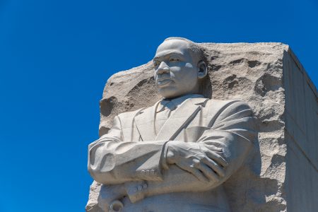 MLK Jr. stone monument busk with blue sky